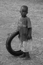 A little boy playing with a used car tyres in the roads of Guadalupe. Royalty Free Stock Photo