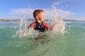 Little boy playing with water on the beach Royalty Free Stock Photo