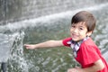 Little boy playing water the fountain Royalty Free Stock Photo