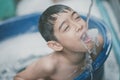 Little boy playing water splash at the backyard outdoor activities summer time Royalty Free Stock Photo