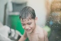 Little boy playing water splash at the backyard outdoor activities summer time Royalty Free Stock Photo