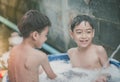 Little boy playing water splash at the backyard outdoor activities summer time Royalty Free Stock Photo