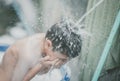 Little boy playing water splash at the backyard outdoor activities summer time Royalty Free Stock Photo