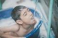 Little boy playing water splash at the backyard outdoor activities summer time Royalty Free Stock Photo