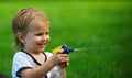 Little boy playing with water spray on hot summer day. Royalty Free Stock Photo