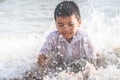 Boy is playing with wave and sand on Pattaya beach Royalty Free Stock Photo