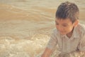 Little boy playing with wave and sand on Pattaya beach Royalty Free Stock Photo