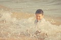 Little boy playing with wave and sand on Pattaya beach Royalty Free Stock Photo