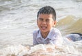 Little boy playing with wave and sand on Pattaya beach Royalty Free Stock Photo