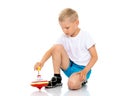 Little boy playing with a whirligig. Royalty Free Stock Photo