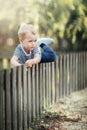 Little boy playing in the yard and learning how to climb over th Royalty Free Stock Photo