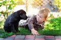 Little boy playing in the yard with a puppy Labrador Royalty Free Stock Photo