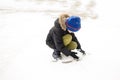 Little boy playing in the yard with snow Royalty Free Stock Photo