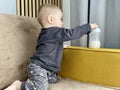 A little boy plays with a baby bottle with a nipple filled with milk formula for feeding Royalty Free Stock Photo