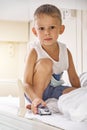 Little boy plays with car toy on top shelf of train carriage Royalty Free Stock Photo