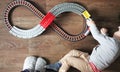 A little boy plays a children`s railway. Mom is watching her son from above. The child is fascinated by the train