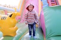 A little boy plays in a colorful children`s trampoline complex o Royalty Free Stock Photo