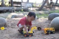 Little boy  plays in the dirt with toy cars. The ultimate playground for boys Royalty Free Stock Photo