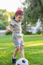 Little boy plays football on the football field gives a pass hits the ball runs across the field and scores a goal Royalty Free Stock Photo