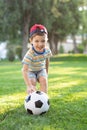 Little boy plays football on the football field gives a pass hits the ball runs across the field and scores a goal Royalty Free Stock Photo