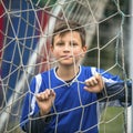 Little boy plays football on stadium. Sport.