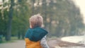 Little boy plays at the fountain in the park