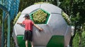 A little boy plays near the ball monument Royalty Free Stock Photo