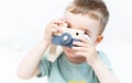 The little boy plays photographer with toy wooden camera Royalty Free Stock Photo