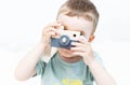 The little boy plays photographer with toy wooden camera Royalty Free Stock Photo