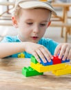 Little boy plays with plastic blocks