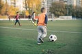 A little boy plays soccer in a city Park gives a pass kicks a ball Royalty Free Stock Photo