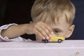 Little boy plays a toy car