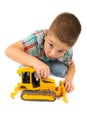 Little boy plays with toy tractor Royalty Free Stock Photo