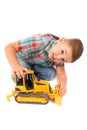 Little boy plays with toy tractor Royalty Free Stock Photo