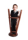 The little boy plays with the turned stool