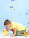 Little boy plays with Easter bunnies. Royalty Free Stock Photo