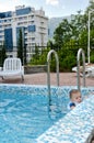 Little boy in a pool hanging onto the edge Royalty Free Stock Photo
