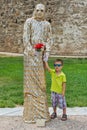 The little boy poses with street performance artist Royalty Free Stock Photo