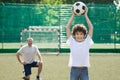 Little boy posing with soccer ball on football field Royalty Free Stock Photo