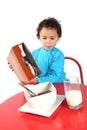 Little boy pouring breakfast cereal