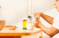 Little boy pouring milk in glass during breakfast Royalty Free Stock Photo