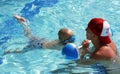Little boy practicing kicks with swim instructor Royalty Free Stock Photo