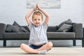 Little boy practicing yoga in lotus position