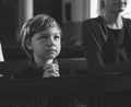 Little boy praying inside a church Royalty Free Stock Photo