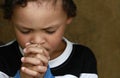 Little boy praying to God with hands held together stock photo Royalty Free Stock Photo