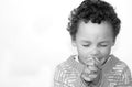 Little boy praying to God with hands held together stock photo Royalty Free Stock Photo