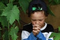 Little boy praying to God with hands held together stock photo Royalty Free Stock Photo