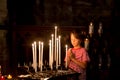 Little boy prays and puts a candle in Orthodox Church Royalty Free Stock Photo