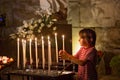 Little boy prays and puts a candle in Orthodox Church Royalty Free Stock Photo
