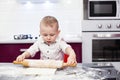 Little boy preparing dough. Boy kneads dough in the kitchen Royalty Free Stock Photo